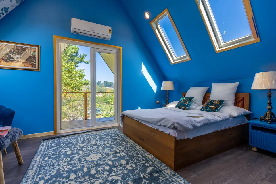 Converted loft bedroom with roof windows and a Juliet balcony